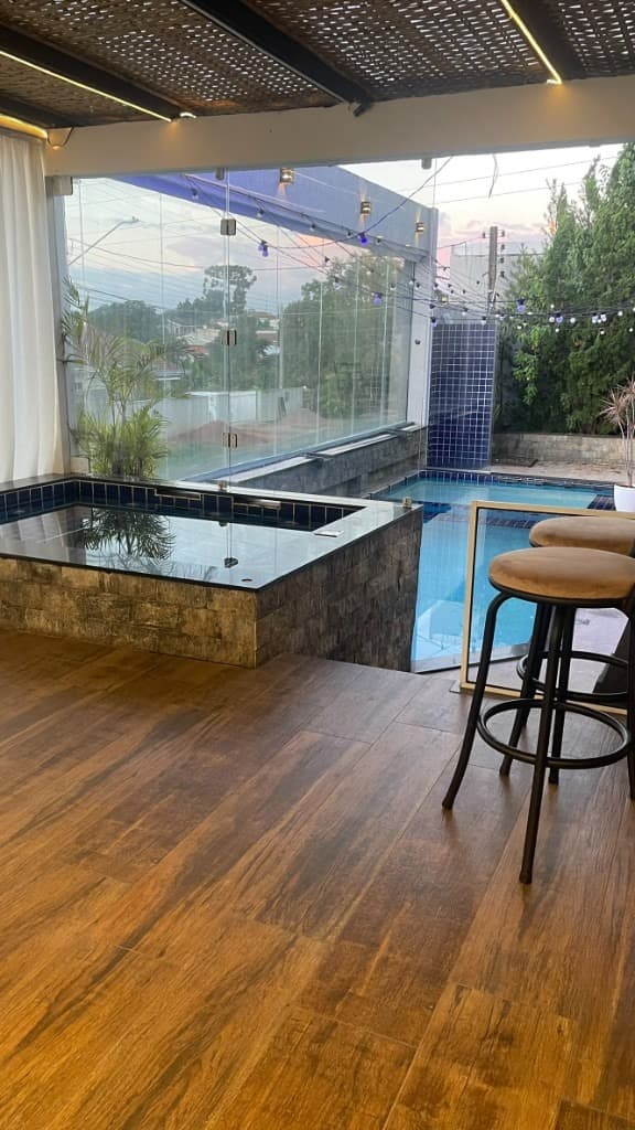 Hidromassagem e piscina com guarda-corpo de vidro e iluminação